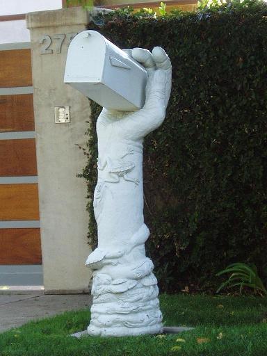 A mailbox shaped like a hand.